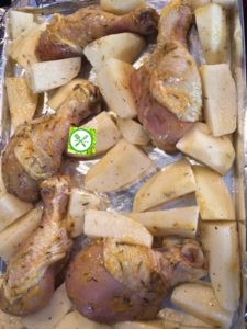 One pan roast potatoes and chicken in a baking sheet